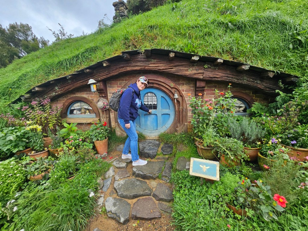 Hobbiton movie set with green hills and hobbit hole doors