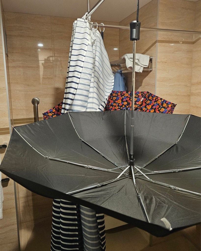 Hanging umbrellas to dry in the hotel washroom.